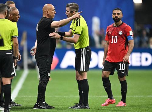 El seleccionador de Egipto, Hossam Hassan, conversa con el árbitro francés François Letexier. (Foto: AFP)