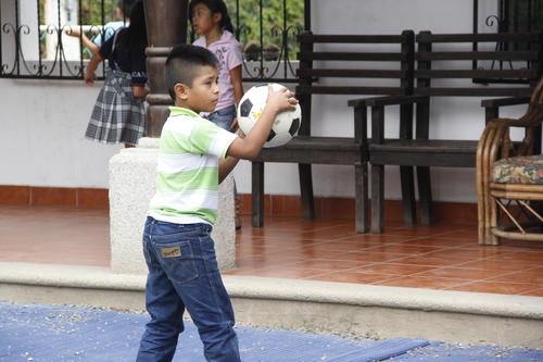 Un niño de Cani se entretiene jugando fútbol en el recreo dentro de las instalaciones del lugar. (Foto: Fredy Hernández/502)