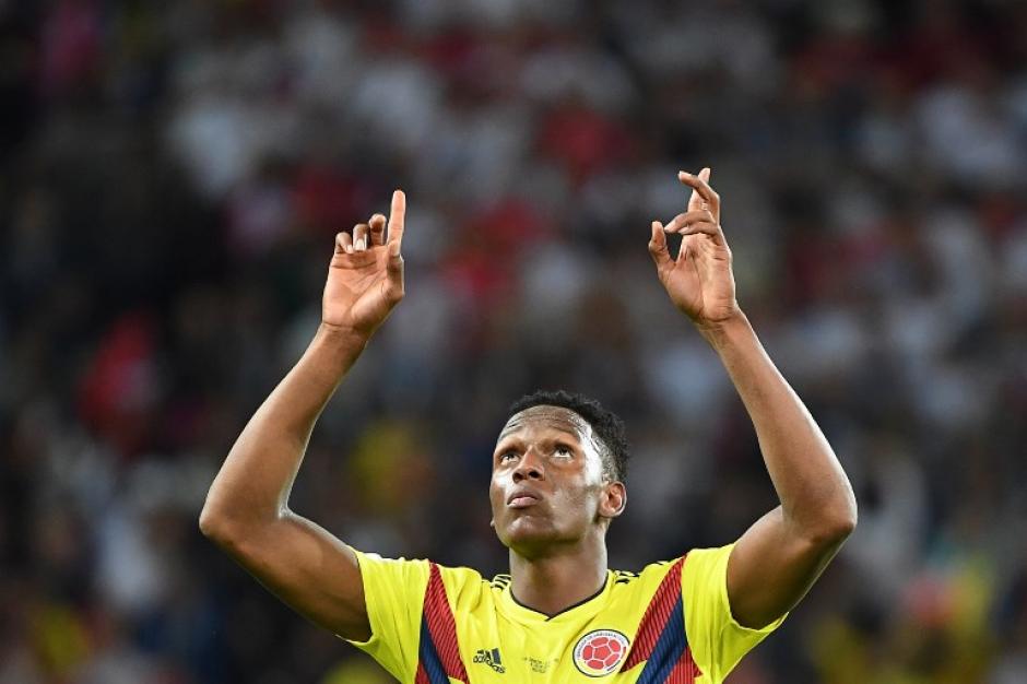 Brazos en alto y vista al cielo en el festejo de Yerry Mina. (Foto: AFP)