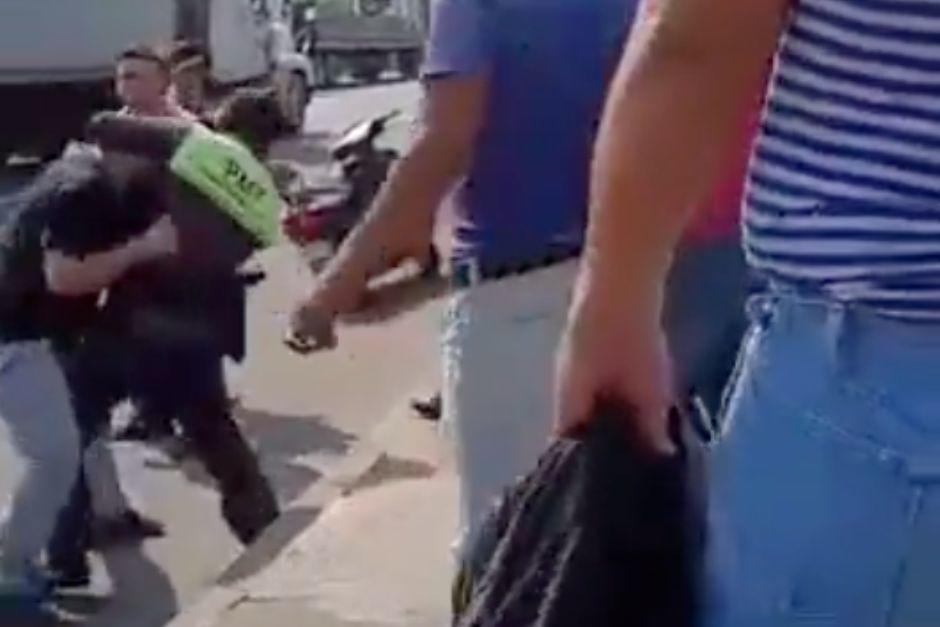 Un piloto y un agente de la PMT de Mazatenango se enfrentaron a golpes aparentemente por la imposición de una multa de tránsito. (Foto: captura de video)