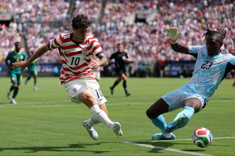 Christian Pulisic de Estados Unidos anota el segundo gol de su equipo contra Mory Diaw de Senegal durante el partido amistoso internacional entre Estados Unidos y Senegal en el Bank of America Stadium. (Foto: AFP)