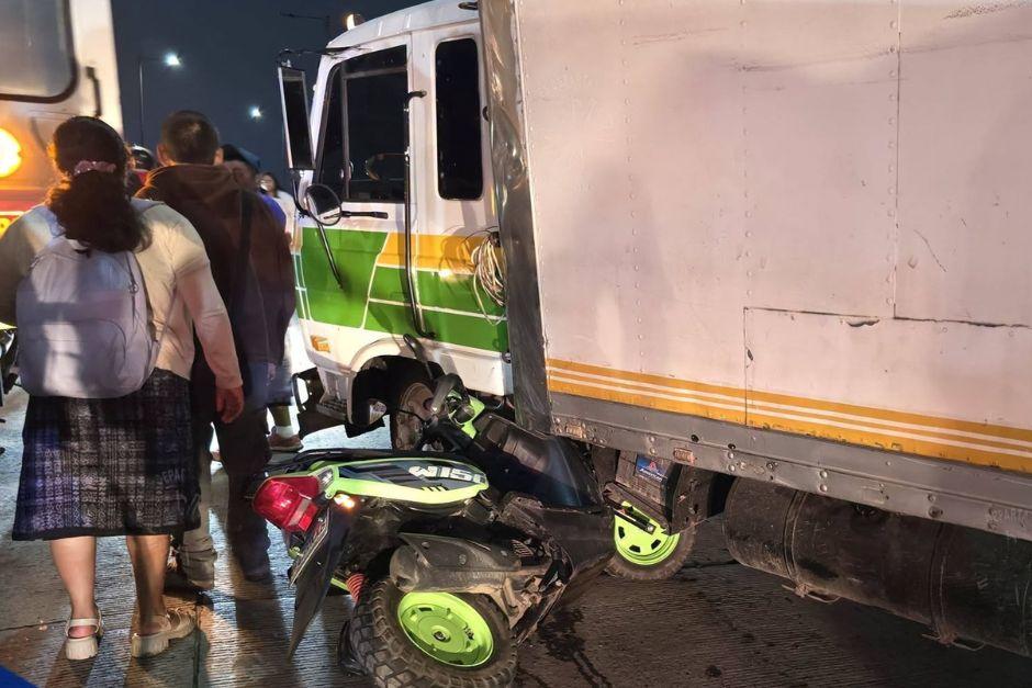 Una de las motocicletas involucradas terminó debajo del camión. (Foto vía: Bomberos Departamentales, El tejar)
