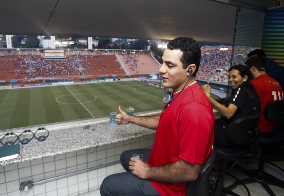 Fabricio utiliza un dispositivo auditivo para escuchar la narración de André, quien se prepara para relatar partidos de Brasil 2014 (AFP).