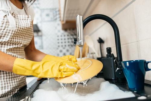 Si tienes piel sensible, protege tus manos con guantes al lavar los platos. (Foto: Shutterstock)