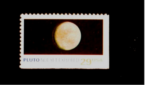 Sello postal de 1991 que dec&iacute;a: "Plut&oacute;n: A&uacute;n no explorado" (Foto: http://pluto.jhuapl.edu/)