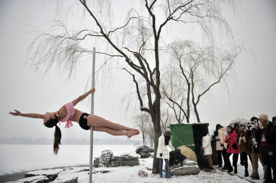 Una bailarina de tubo china es captada tras un nevada en Tianjin, China. (AFP)&nbsp;