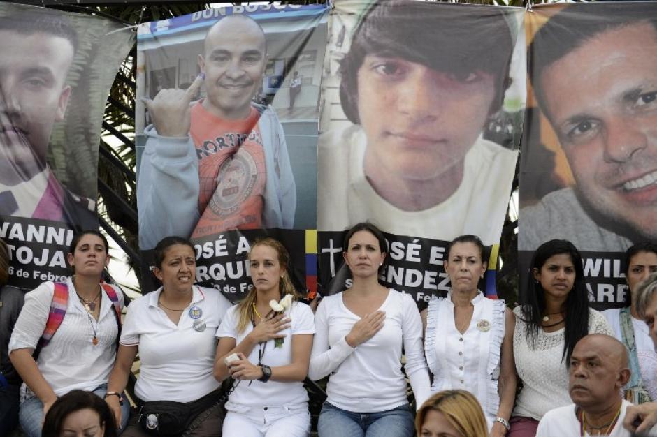 Las pancartas con los rostros de las 18 v&iacute;ctimas mortales fueron colgadas en las rejas que encierran el aeropuerto La Carlota de Caracas. (Foto: AFP)