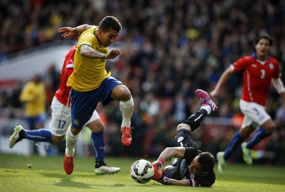 Momento exacto en que Firmino ha dejado atr&aacute;s a Bravo y se alista a rematar y anotar el 1-0 de Brasil sobre Chile. (Foto: AFP)