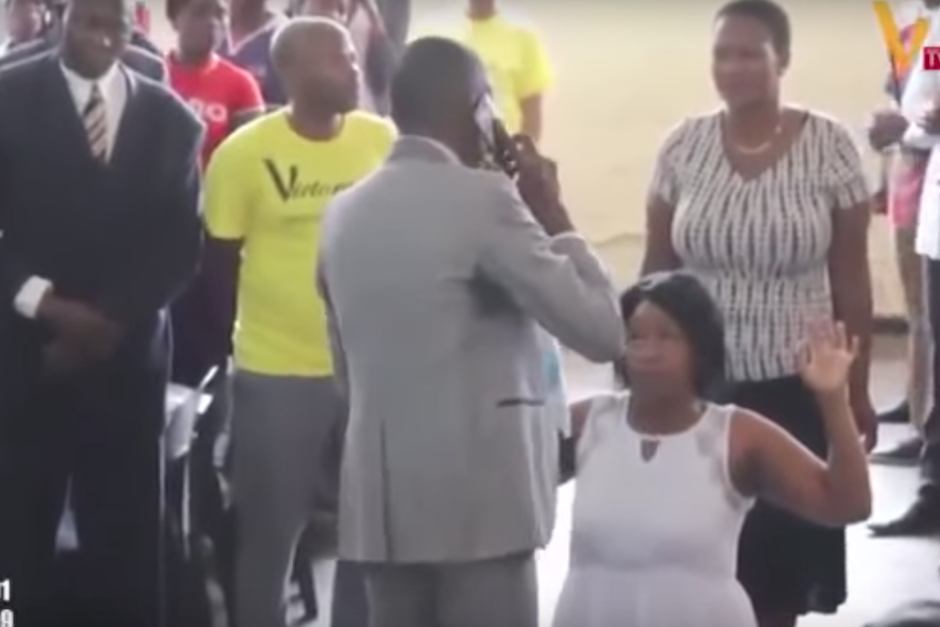 Con el tel&eacute;fono en mano, el predicador transmite el mensaje que "dios" le da a una mujer. (Imagen: captura de pantalla)