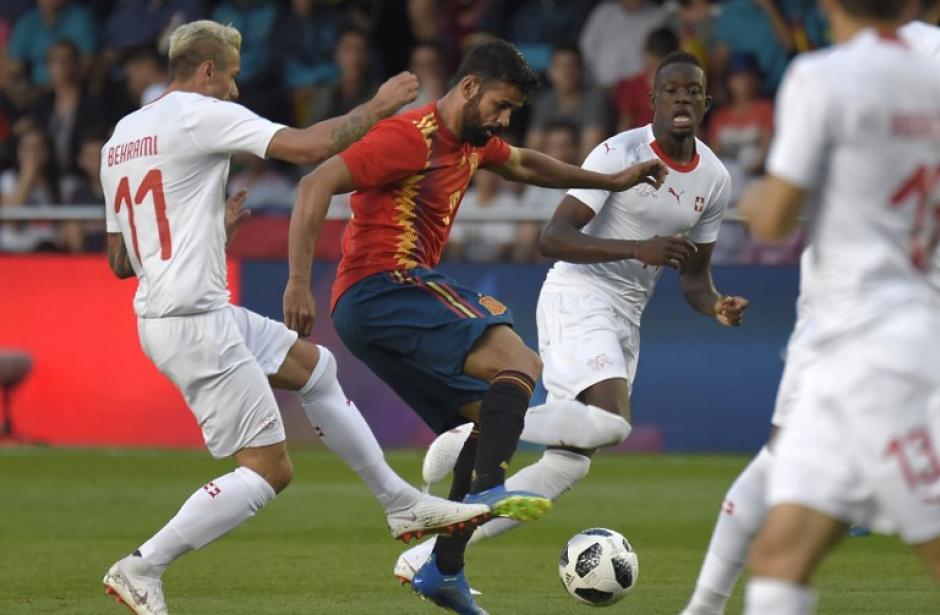 El espa&ntilde;ol Diego Costa disputa el bal&oacute;n con dos marcadores suizos. (Foto: AFP)