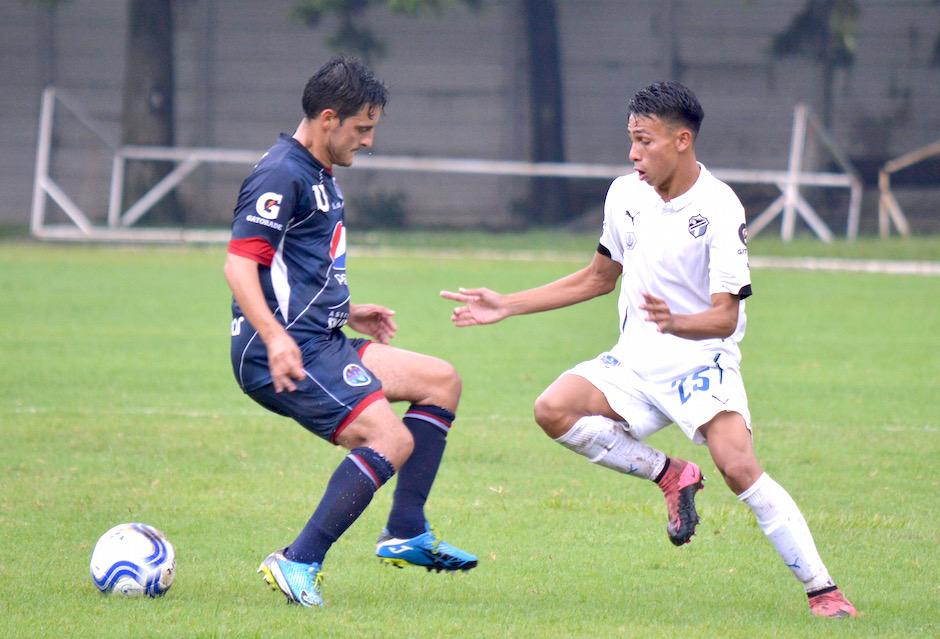 Lyner García, de Comunicaciones, disputa el balón con David Acajabón, de la Universidad. (Foto: Rudy Martínez/Soy502)