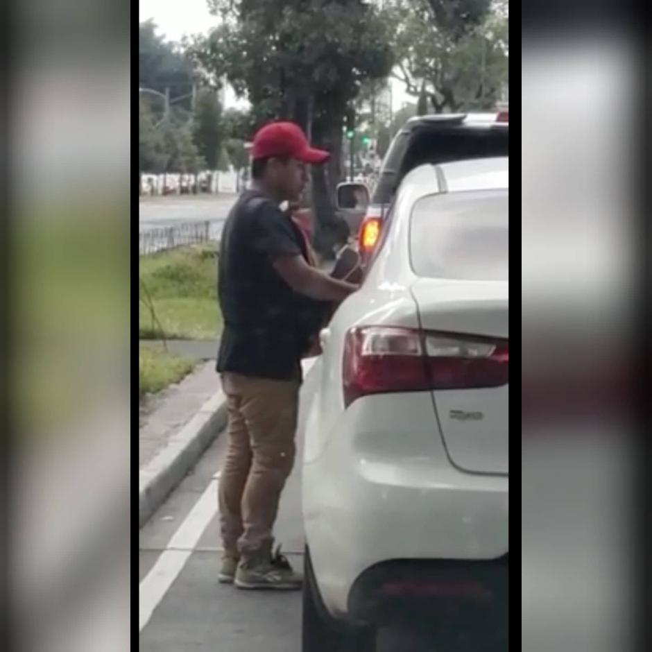 Los ocupantes de un carro graban cómo el hombre asalta a los del vehículo de adelante. (Foto: captura pantalla)&nbsp;