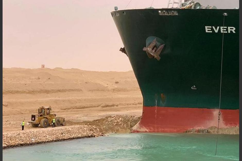 Las primeras labores para tratar de liberar el enorme buque fue de la retroexcavadora. (Foto: AFP)