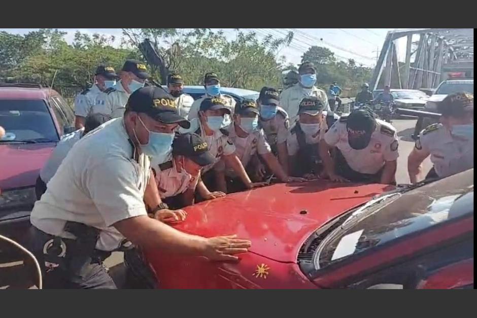 Agentes de la PNC se vieron obligados a empujar los veh&iacute;culos para que pasara un ambulancia. (Foto: Noticias El Quetzal)