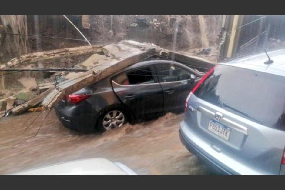 Varios vehículos reportaron con daños al caer un paredón. (Foto: Municipalidad de Mixco)