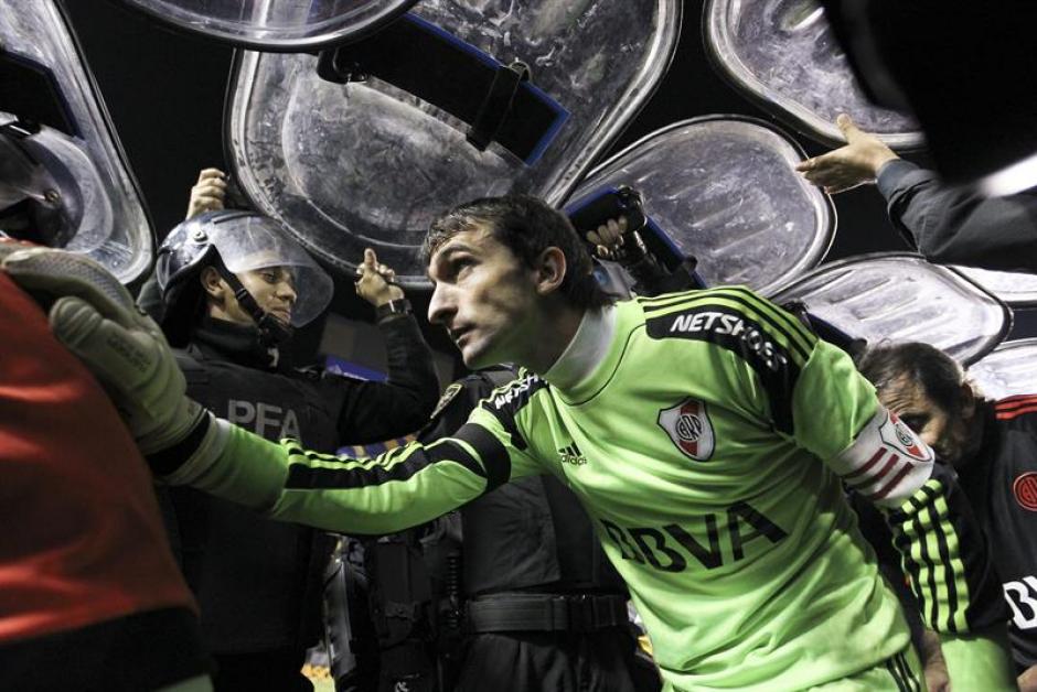 Marcelo Barovero de River Plate abandona el estadio luego de que lanzaran gas pimienta desde la tribuna. &nbsp;(Foto: EFE)
