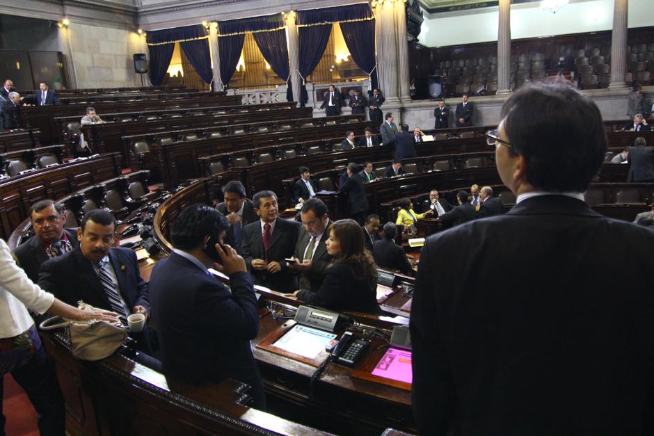 Un diputado observa al fondo del hemiciclo del Congreso, donde se percibe la ausencia total de la bancada de Lider. Seg&uacute;n el presidente del Congreso, Luis Rabb&eacute;, estos no ser&aacute;n sancionados, pese a que es evidente que bloquean las reformas a la Ley Electoral, pero Rabb&eacute;, tambi&eacute;n es de Lider. (Foto: Alexis Batres/Soy502)